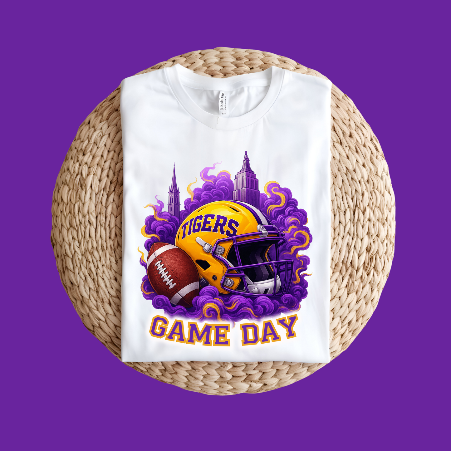 White t-shirt with football helmet and 'Tigers Game Day' design on a woven mat and purple background Tigers Game Day Tee - Bold Fan Game Day Tigers Football T-Shirt