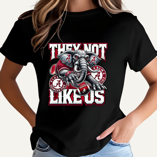 Black t-shirt with an elephant graphic and text on a plain background Alabama Football "They Not Like Us" Alabama Crimson Tide T-Shirt