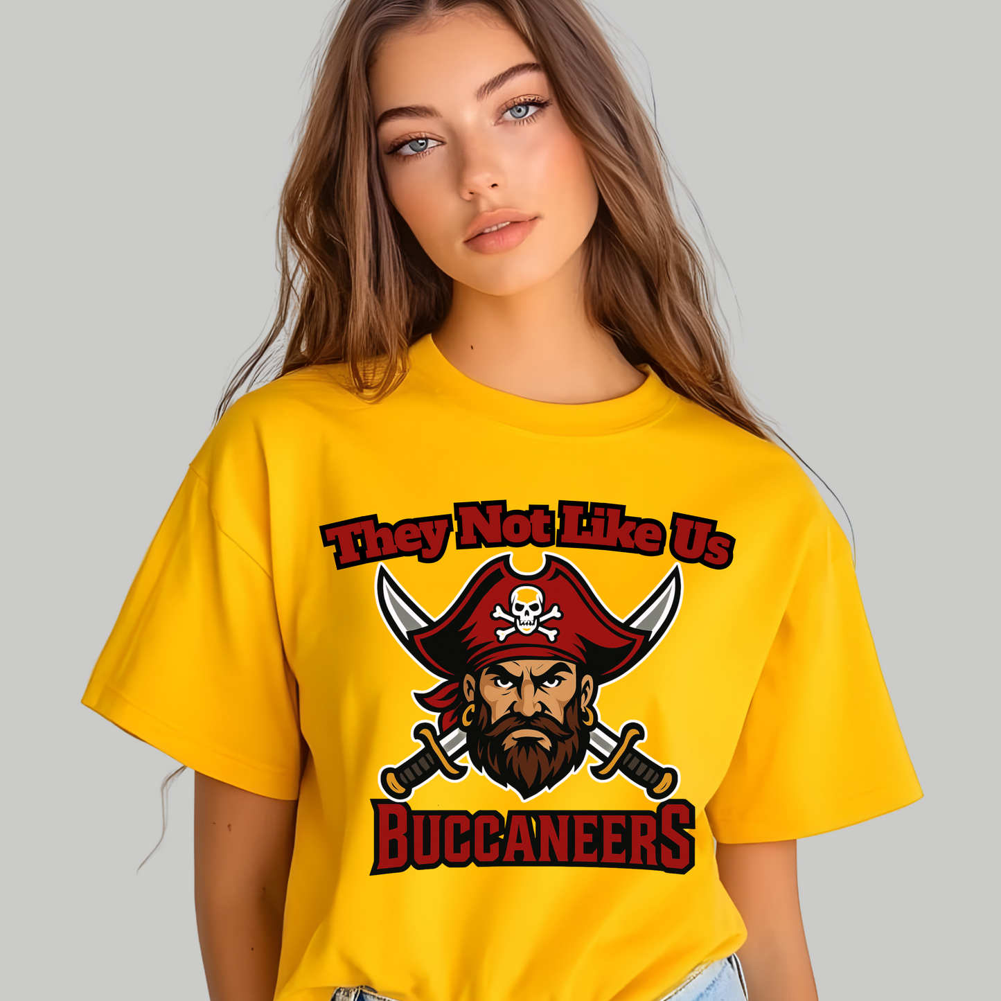 Person wearing a yellow t-shirt with a Buccaneers graphic design on a gray background Custom Mascot Shirt - Buccaneers They Not Like Us Game Day Wear