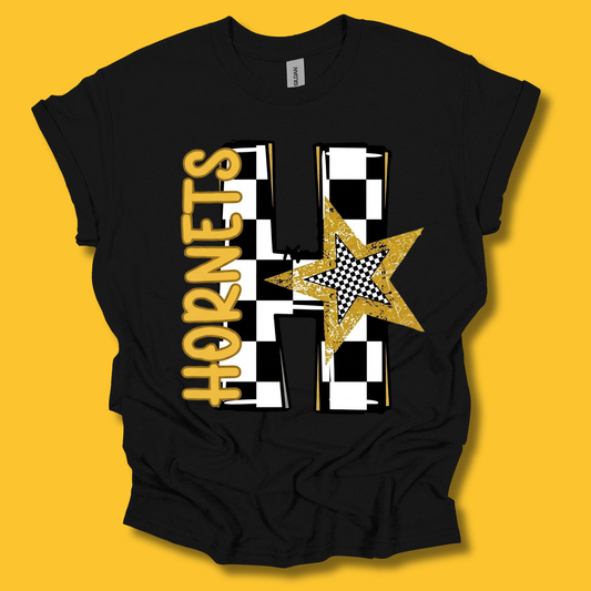A black short-sleeve t-shirt with a custom graphic design featuring the word 'HORNETS' in gold, a gold glitter star, and a black-and-white checkered pattern, displayed against a solid yellow background.
