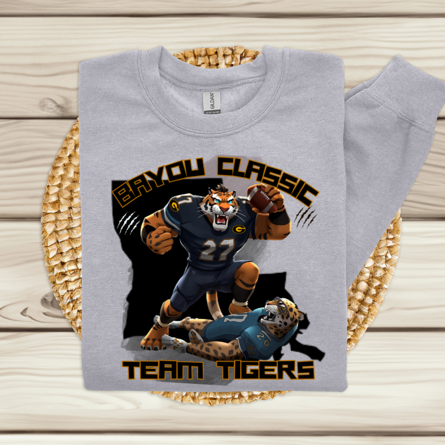 Gray sweatshirt with 'Bayou Classic Team Tigers' design on a woven mat. Bayou Classic Team Tigers: Grambling Tigers Bayou Classic Cozy Game Day Sweater
