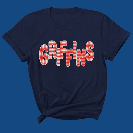 A navy blue short-sleeve t-shirt with the word 'GRIFFINS' printed across the chest in a red-and-white checkered pattern, shown against a solid blue background.