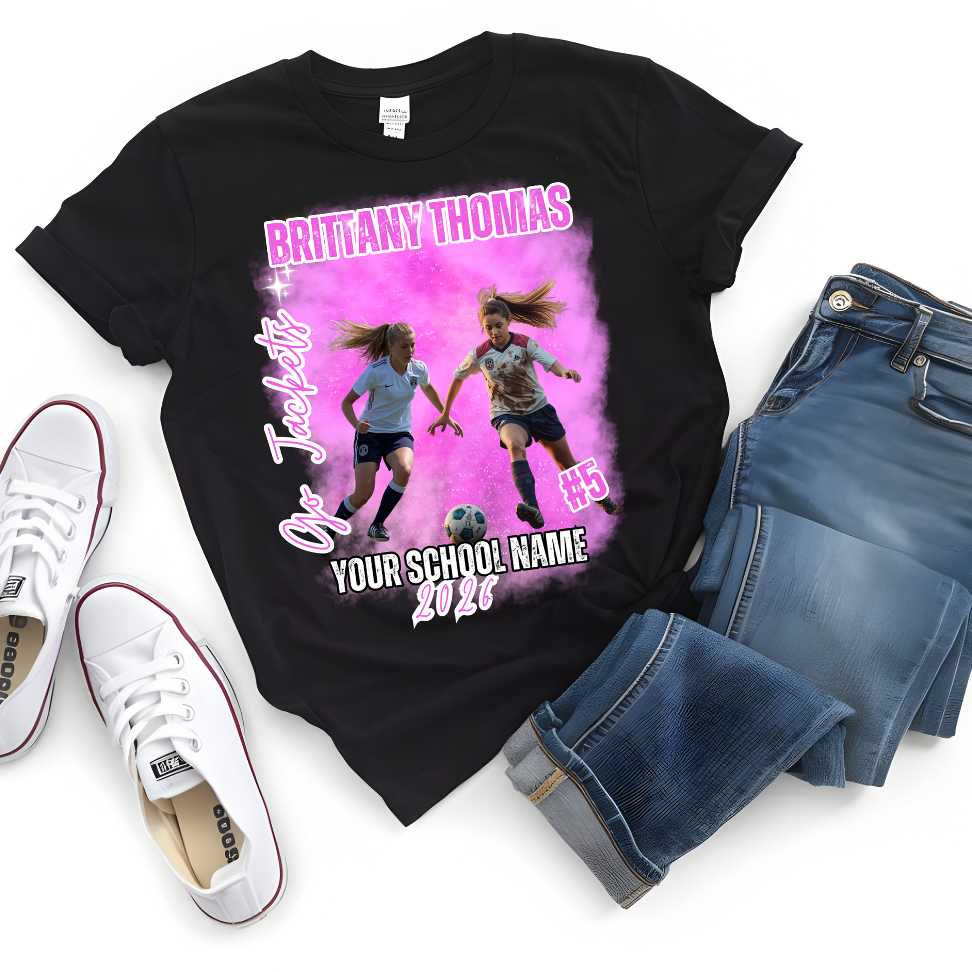 Black t-shirt with soccer-themed design, jeans, and white sneakers on a white background  Customizable graduation photo t-shirt featuring senior portrait, school mascot, and sports organization logos in school colors