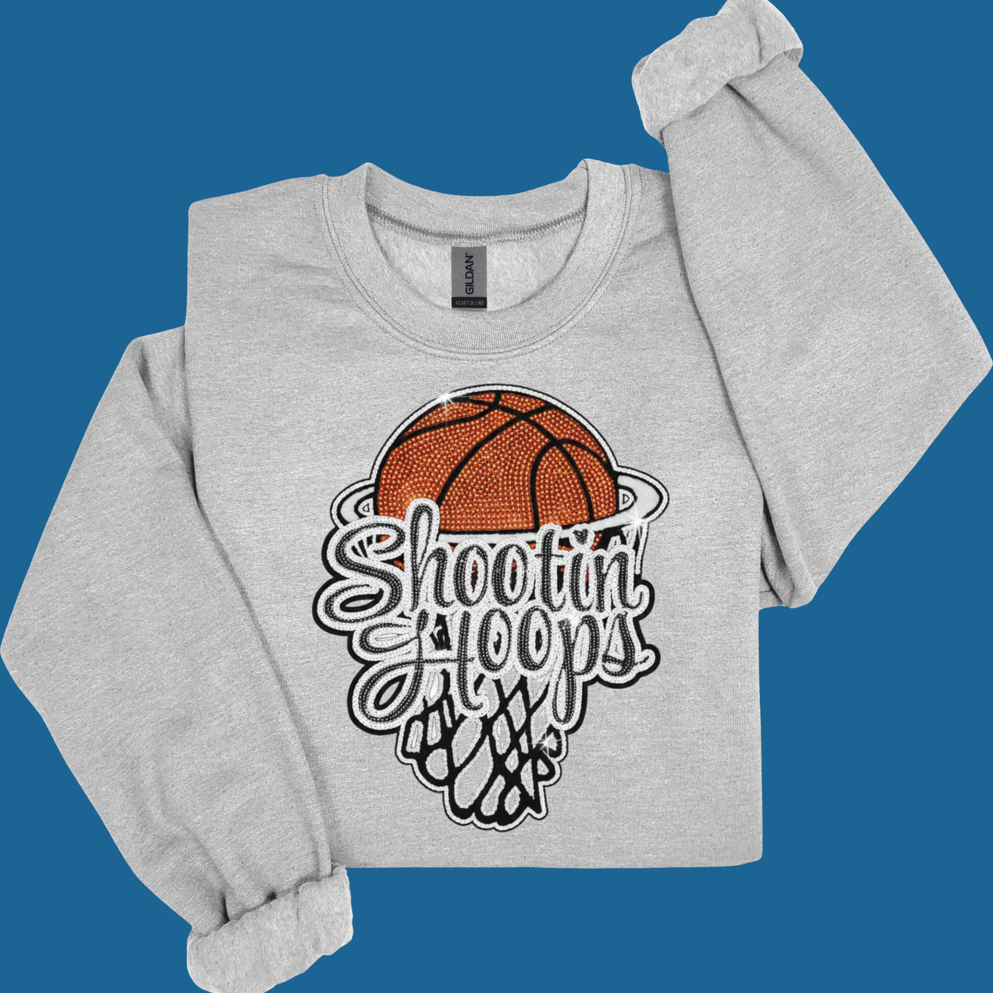 Gray sweatshirt with basketball graphic and text on a blue background
