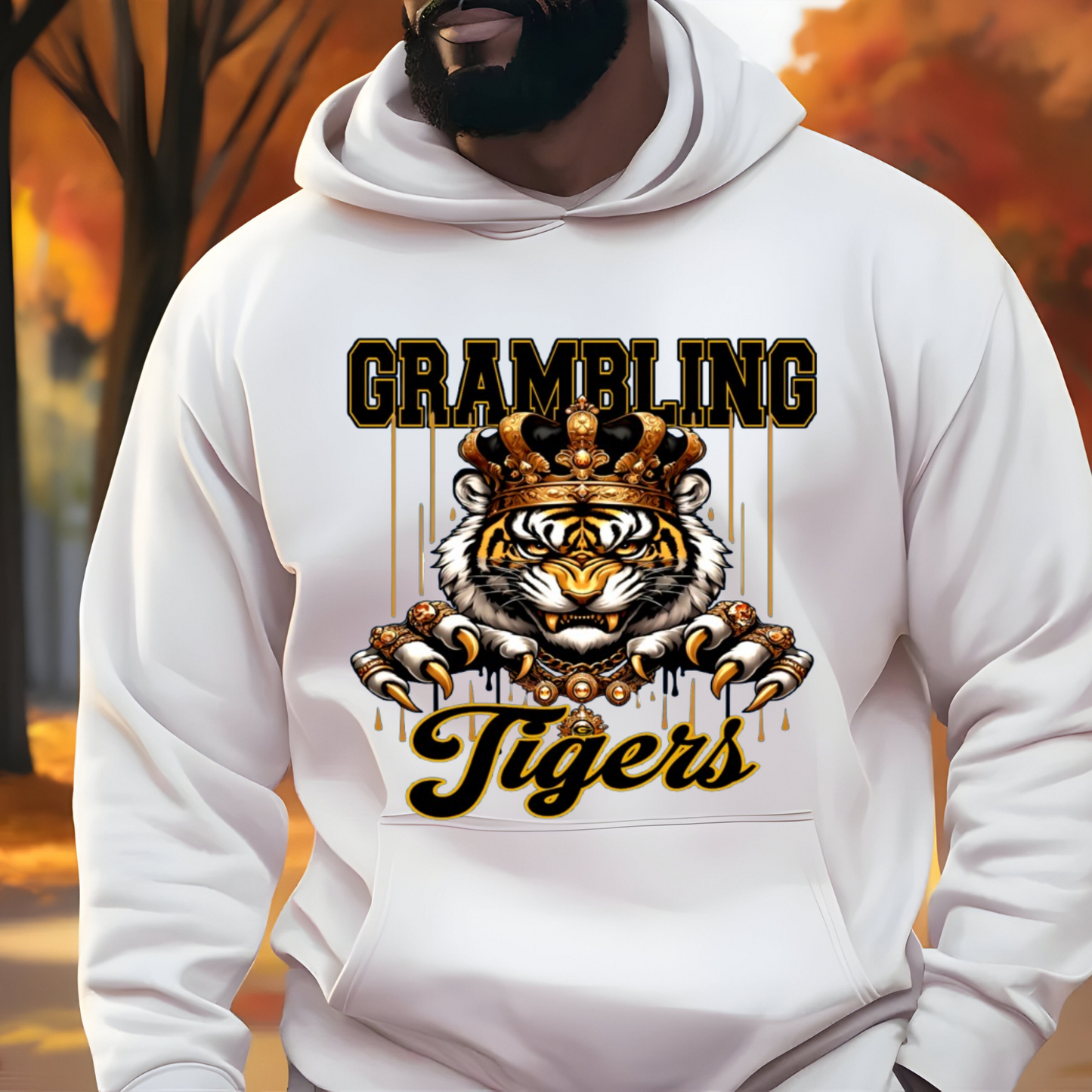 A white pullover hoodie worn by a man, featuring a large graphic print on the front with the words 'GRAMBLING Tigers' and an illustration of a tiger wearing a gold crown and jewelry.