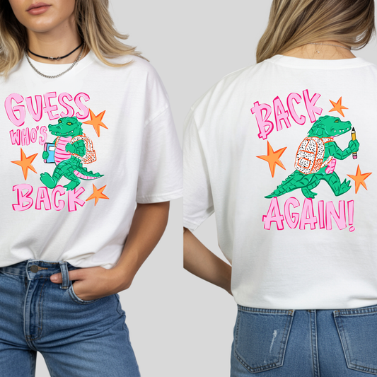 A white graphic t-shirt featuring a green alligator carrying a pink backpack with the text 'GUESS WHO'S BACK' on the front and 'BACK AGAIN!' on the back, shown on a model from both front and back views.
