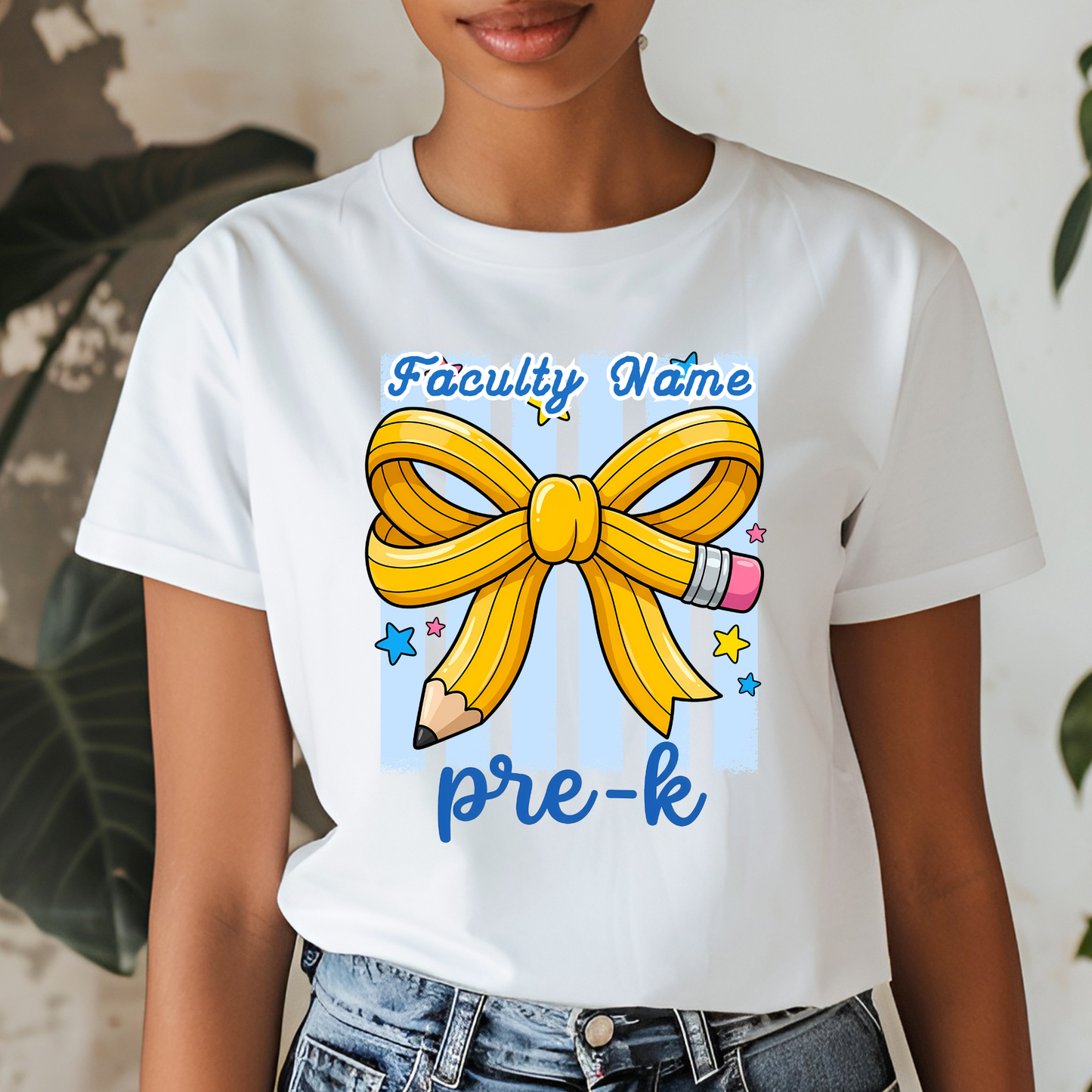 A woman wearing a white graphic t-shirt with a yellow ribbon bow, pencil, and blue text reading 'Faculty Name pre-k'.