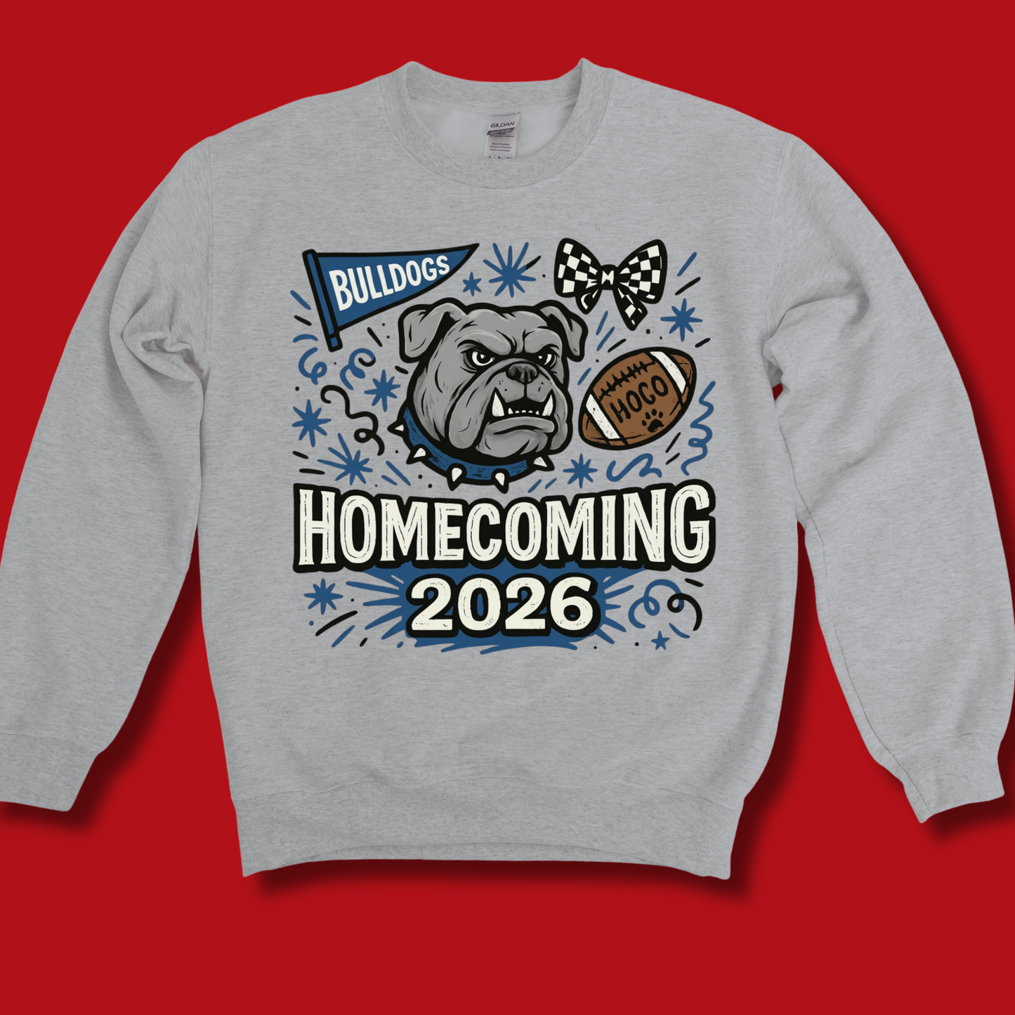 A light heather gray crewneck sweatshirt featuring a 'Bulldogs Homecoming 2026' graphic print on the front, displayed against a solid red background.