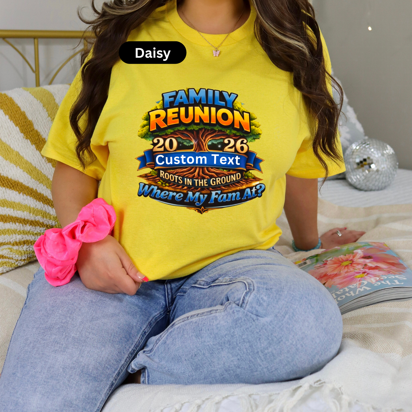 Person wearing a yellow 'Family Reunion' t-shirt with customizable text, sitting on a couch.