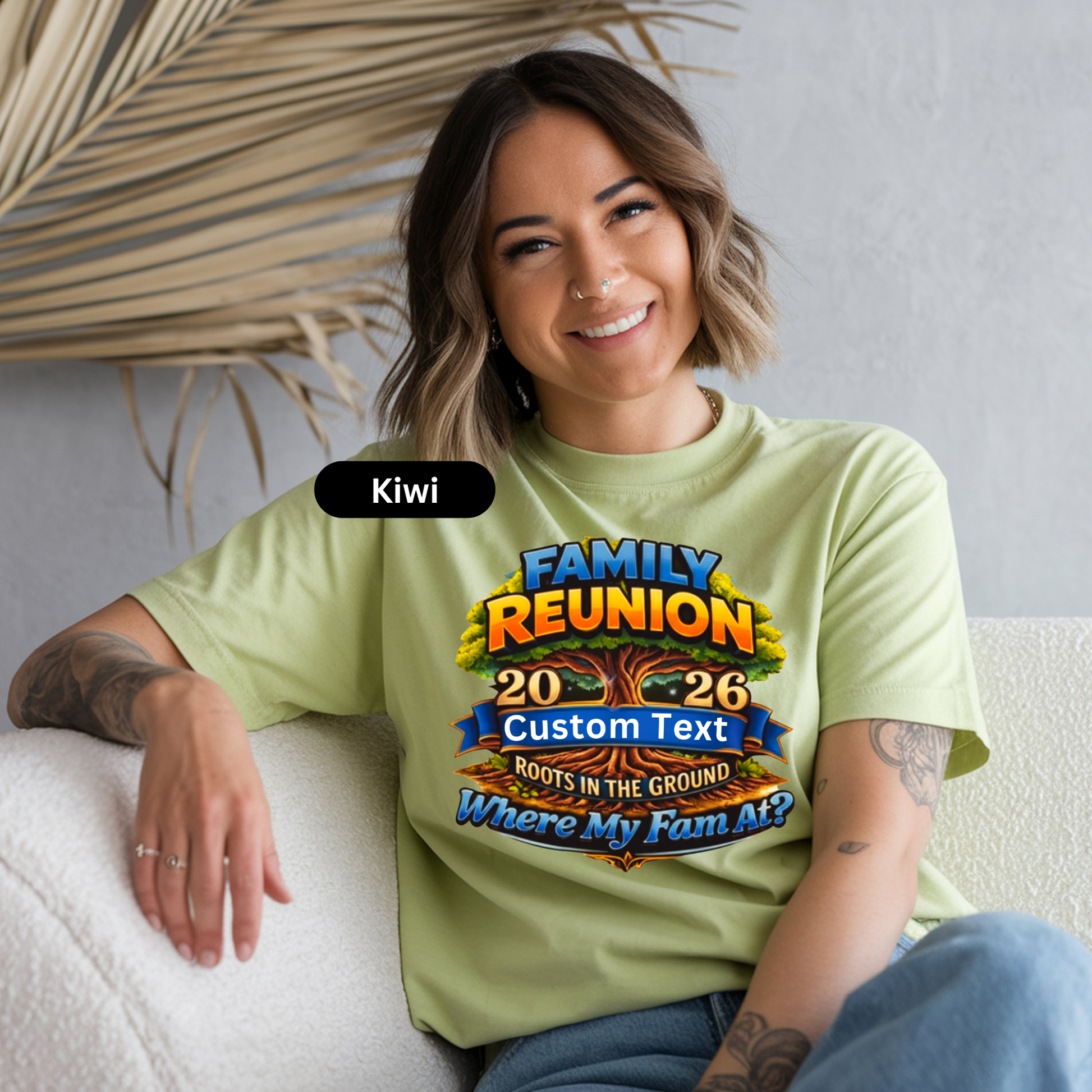 Woman wearing a light green t-shirt with a family reunion design, sitting on a white couch.