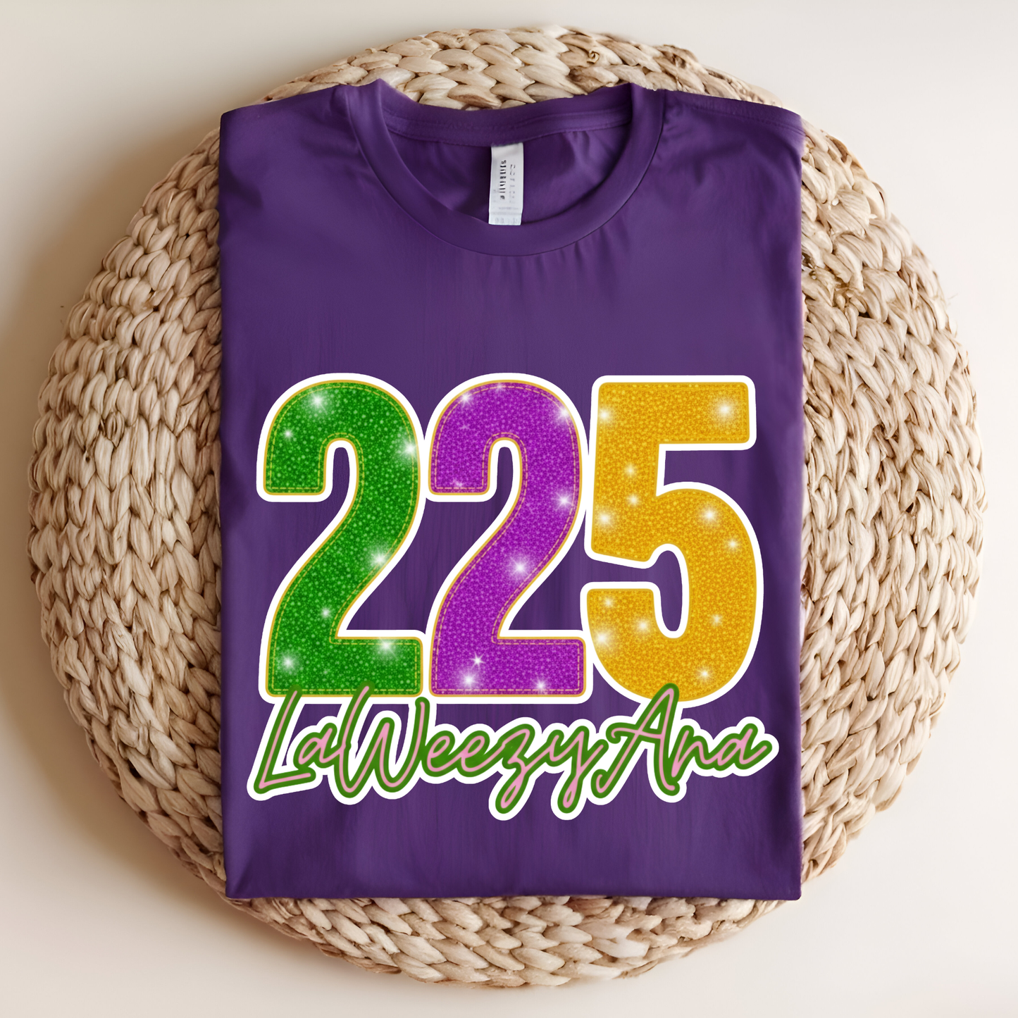 Purple t-shirt with colorful numbers and text on a woven mat