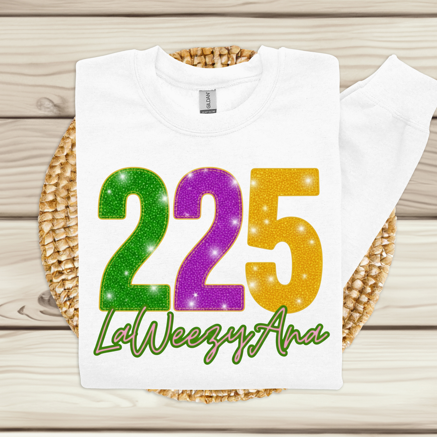 White t-shirt with colorful numbers and text on a woven mat