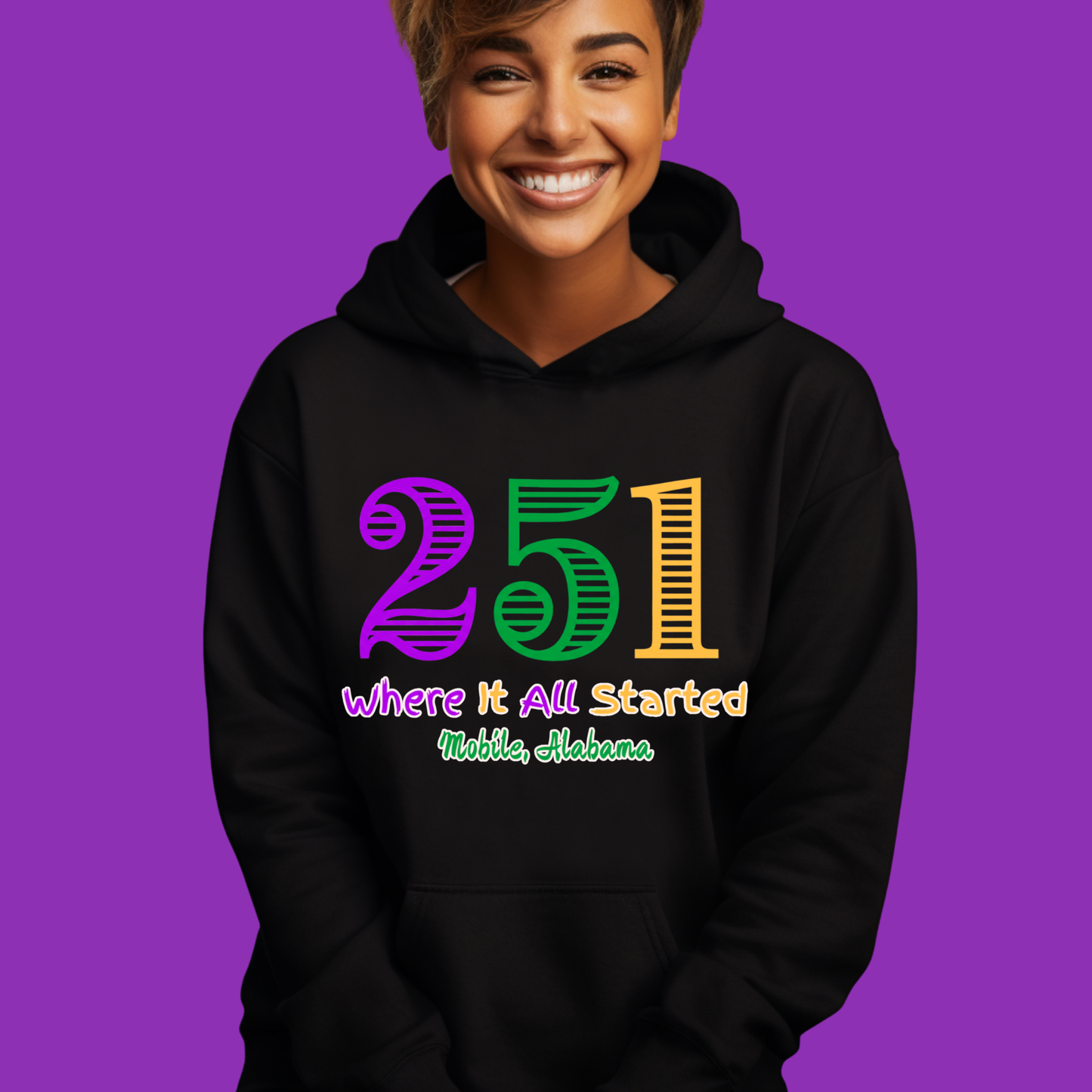 Person wearing a black hoodie with colorful text on a purple background