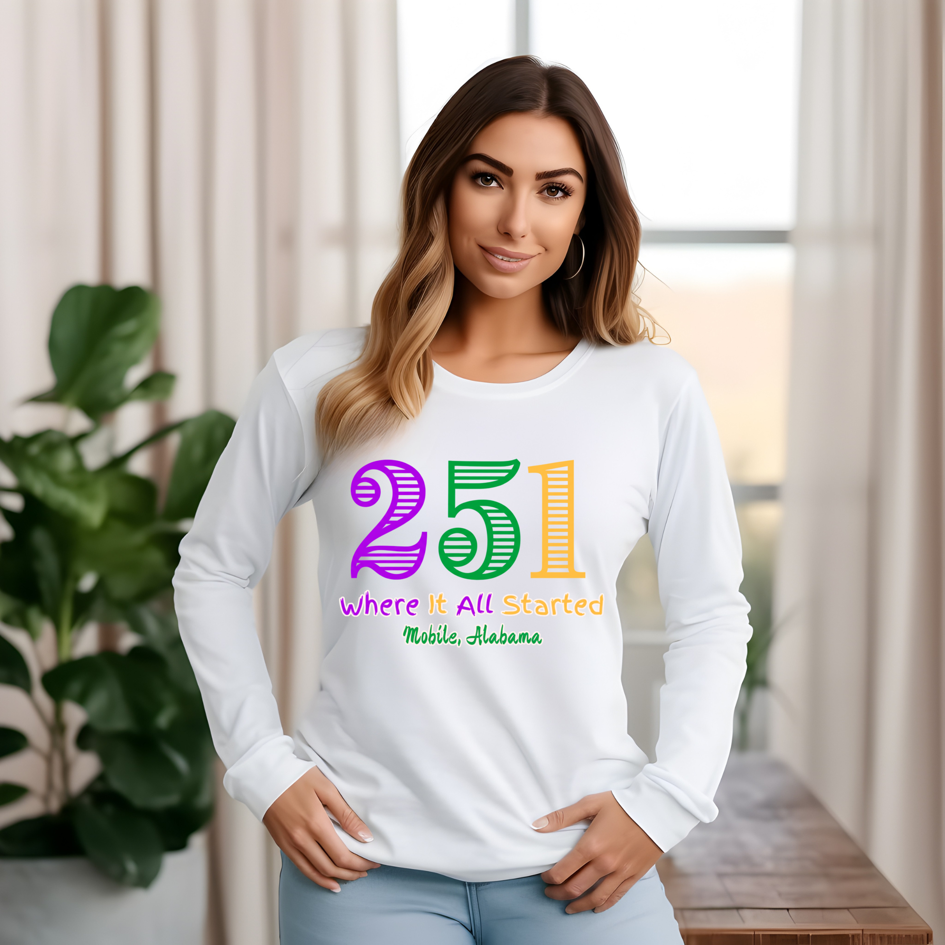 Woman wearing a white long-sleeve shirt with colorful text in a home setting