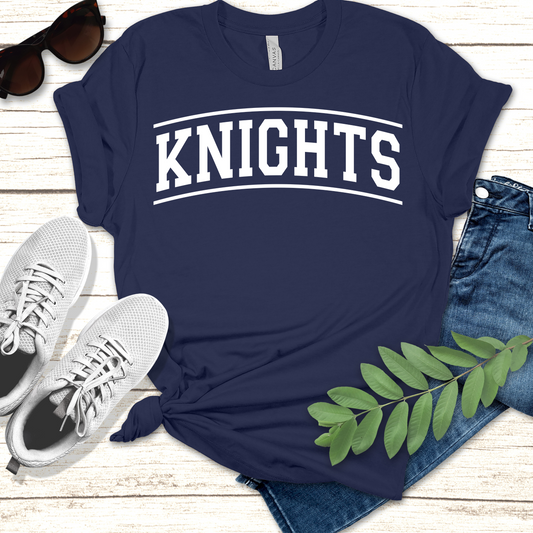Navy blue t-shirt with 'KNIGHTS' text, paired with jeans, sneakers, and sunglasses on a wooden surface. Knights School Spirit Shirt - Knights Fan Merch - School Pride Graphic T-Shirt