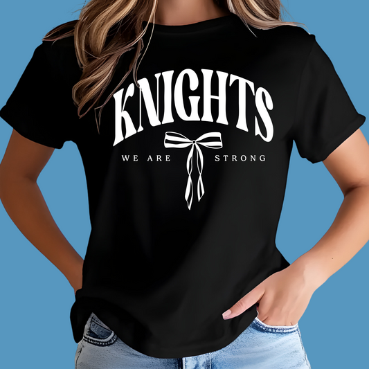 Person wearing a black t-shirt with 'KNIGHTS WE ARE STRONG' text and design. Knights School Spirit Shirt - Knights We  Are Strong - Knights Spirit Tee