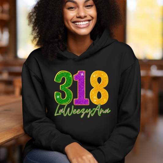 Person wearing a black hoodie with colorful text '318 LaWeezyAna' in an indoor setting.