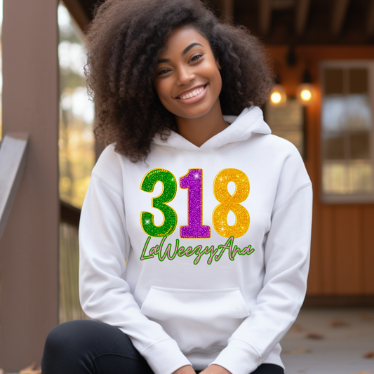 Person wearing a white hoodie with colorful text sitting outdoors.