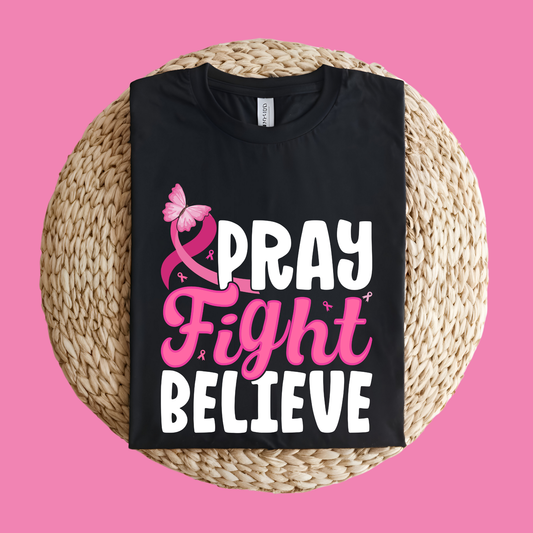 Black t-shirt with 'Pray Fight Believe' text on a pink   Pink Ribbon T-Shirt: Pray Fight Believe Graphic Awareness Tee