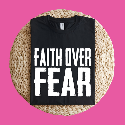 Black t-shirt with 'Faith Over Fear' text on a woven mat with a pink background Pink Ribbon Tee: FAITH OVER FEAR Bold Support Statement T-Shirt