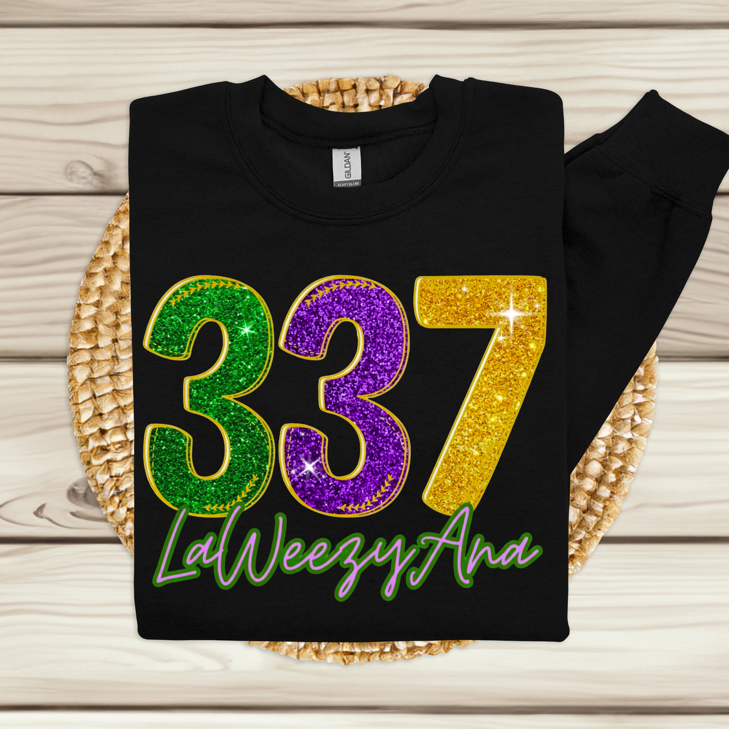 Black sweatshirt with colorful numbers and text on a wooden surface
