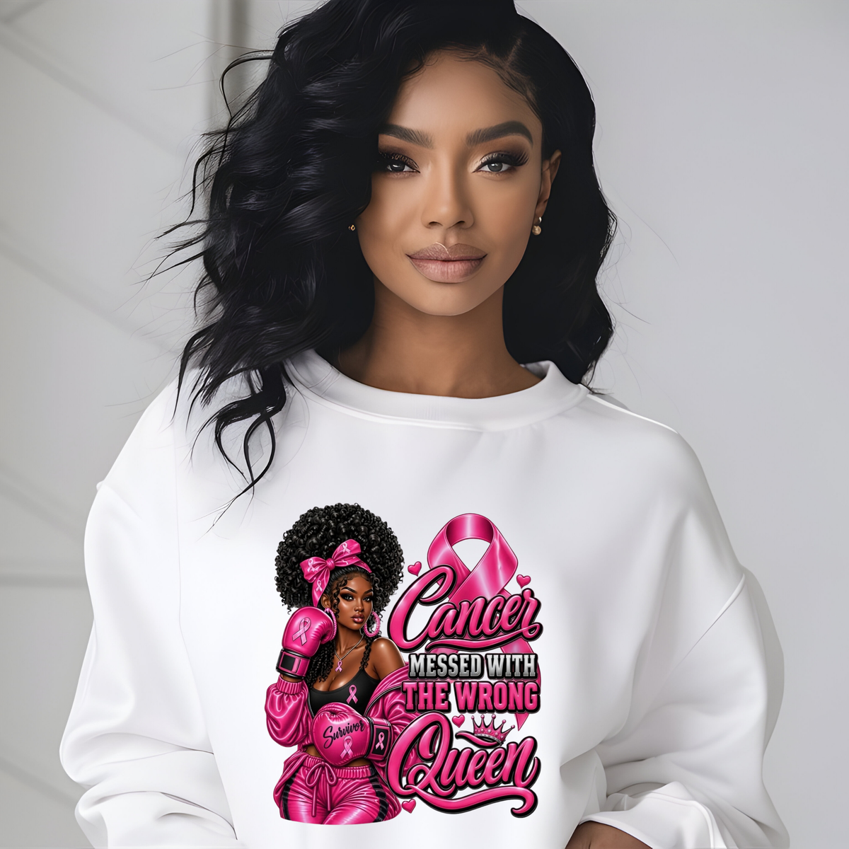 A woman wearing a white crewneck sweatshirt with a pink graphic print that reads 'HER Fight IS OUR Fight' alongside a pink ribbon and illustrated figures, set against a light gray background.