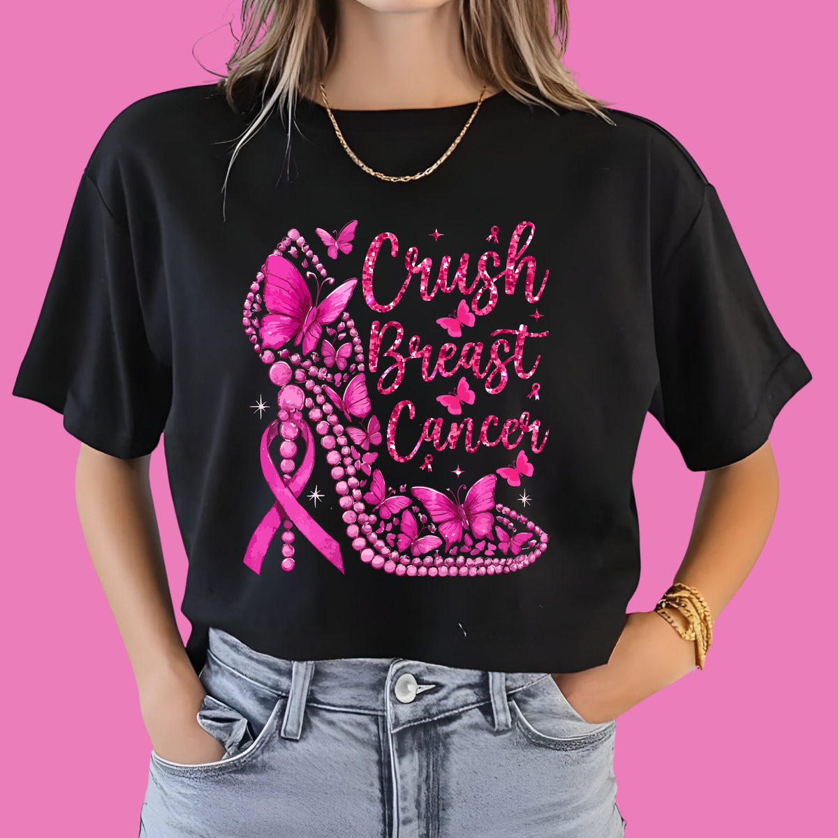 Black t-shirt with pink breast cancer awareness design on a pink background