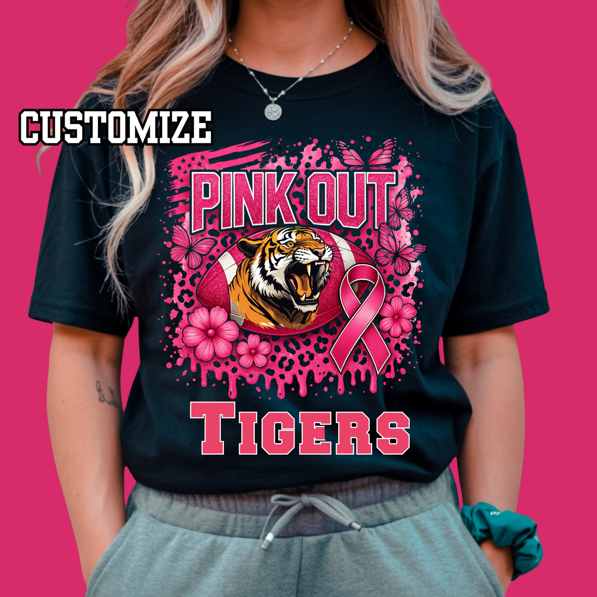 Black t-shirt with pink tiger graphic and text on a pink background