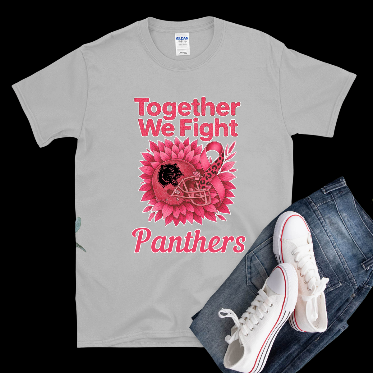 Gray t-shirt with pink graphic and text, white sneakers, and blue jeans on a black background