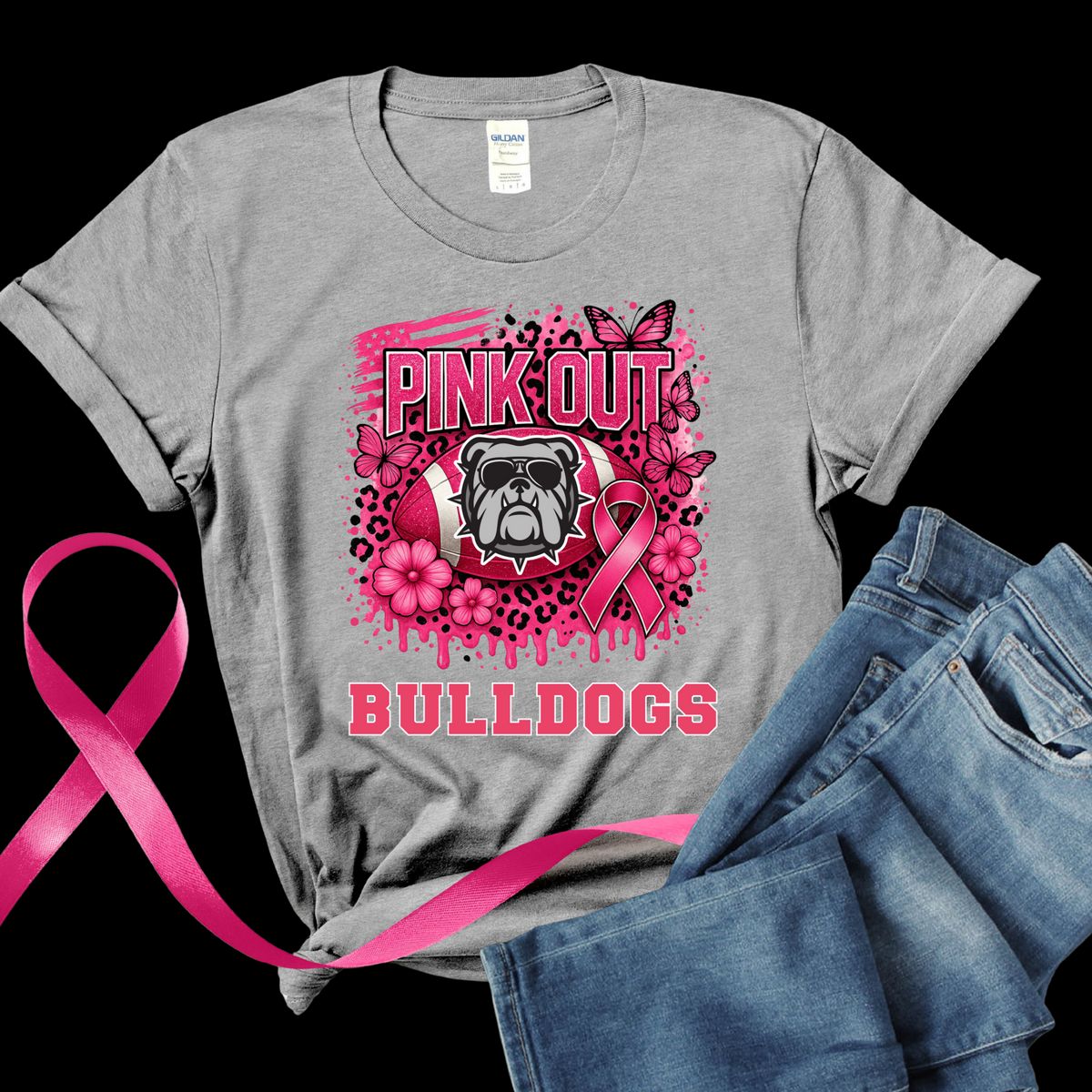 Gray t-shirt with pink bulldog graphic and pink ribbon, paired with jeans on a black background