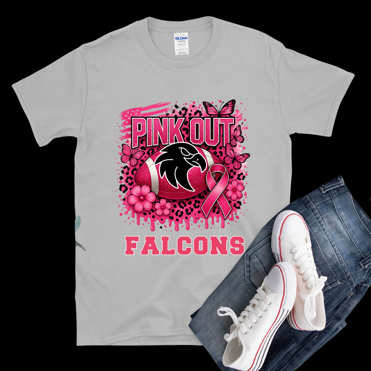 Gray t-shirt with pink 'Out' and 'Falcons' design, paired with jeans and white sneakers on a black background.