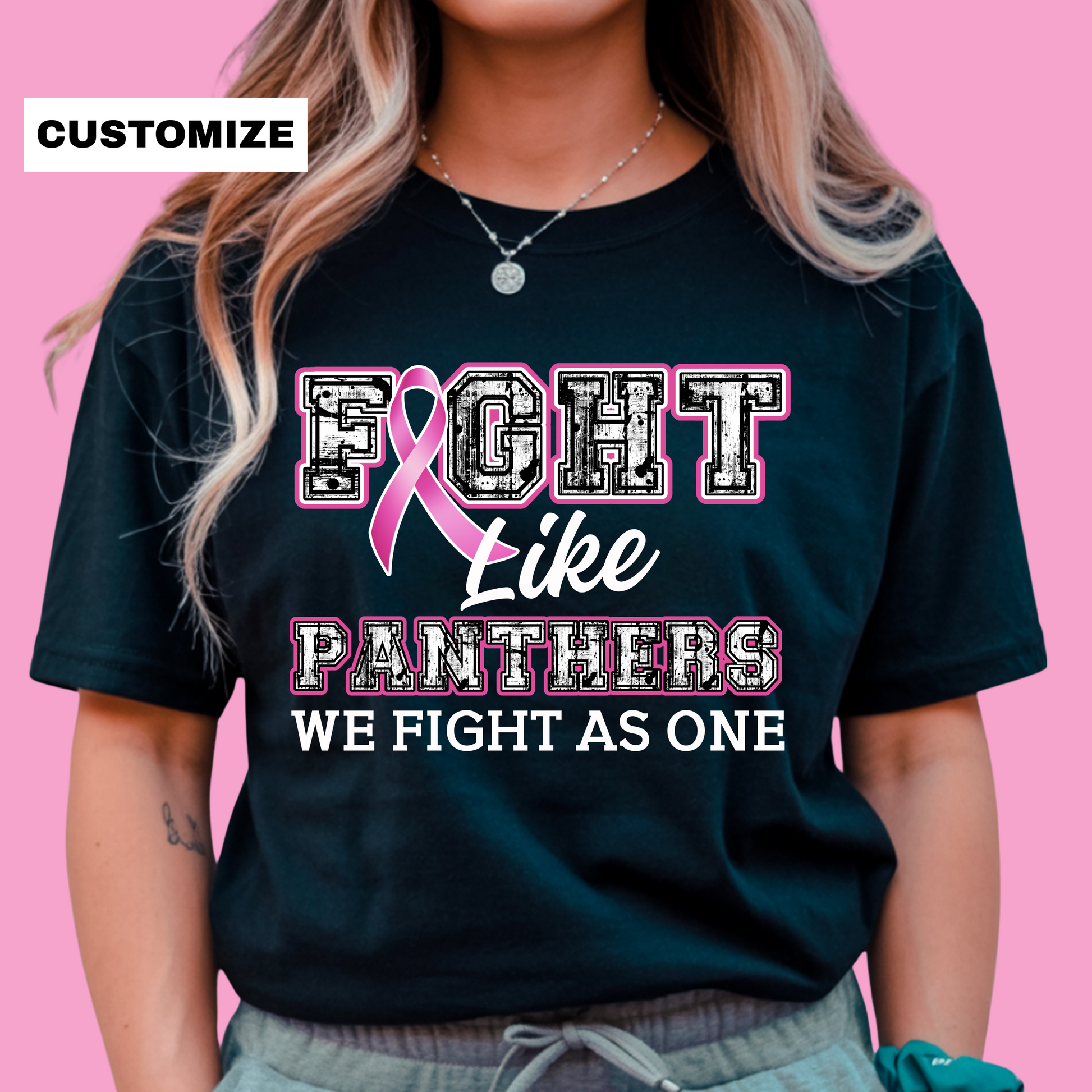 Person wearing a black t-shirt with a pink ribbon design and text on a pink background Custom Mascot T-Shirt: Fight Like a "Mascot" - Game Day Breast Cancer Support Tee