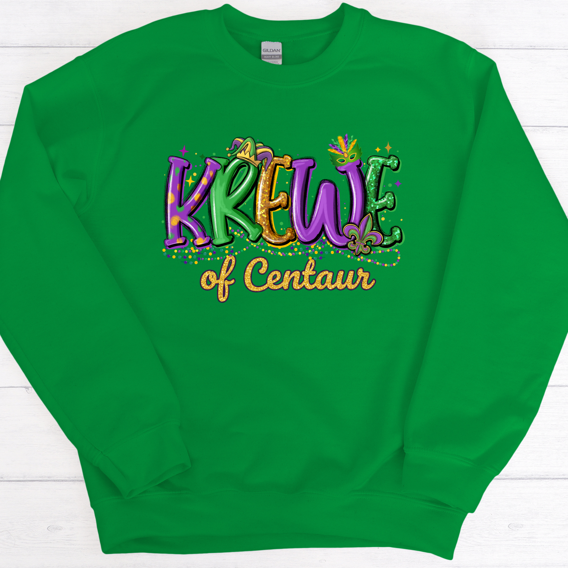 Green sweatshirt with colorful text 'Krew of Centaur' on a white wooden background