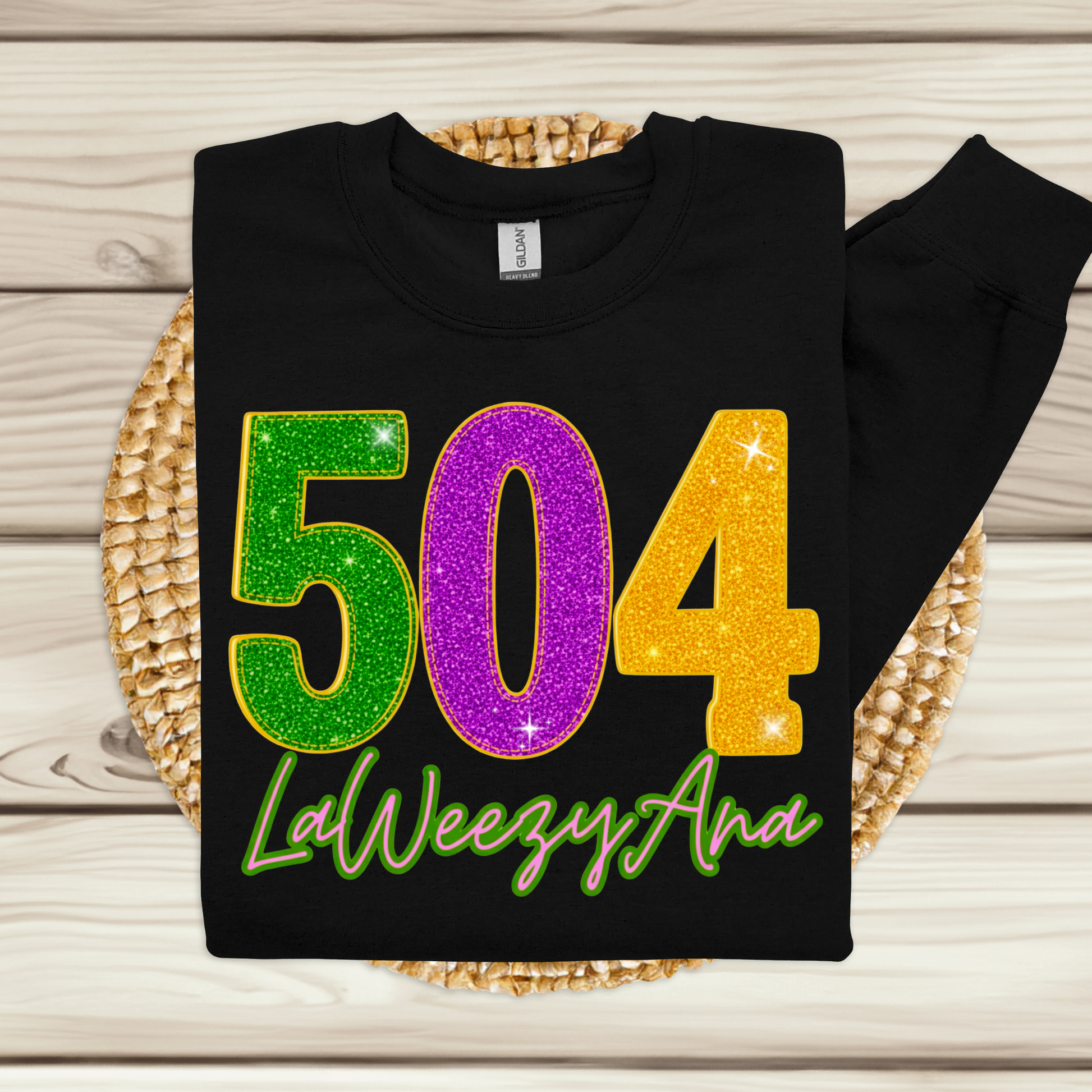 Black sweatshirt with colorful numbers and text on a wooden surface