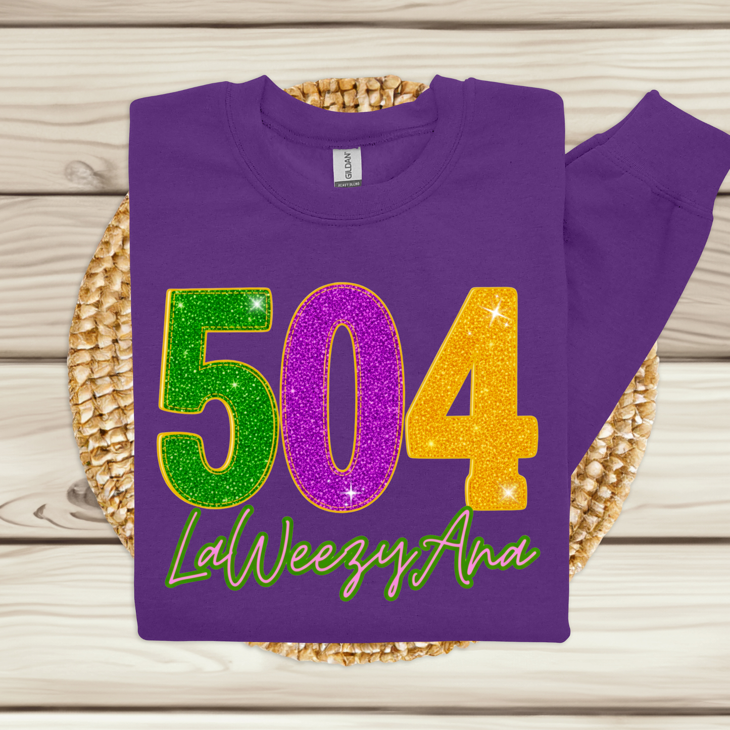 Purple sweatshirt with colorful numbers and text on a wooden surface