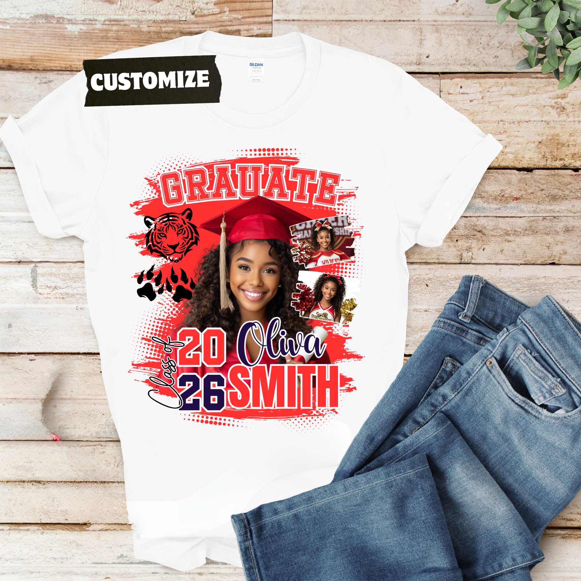 White t-shirt with graduation design and jeans on a wooden surface   Customizable graduation photo t-shirt featuring senior portrait, school mascot, and sports organization logos in school colors