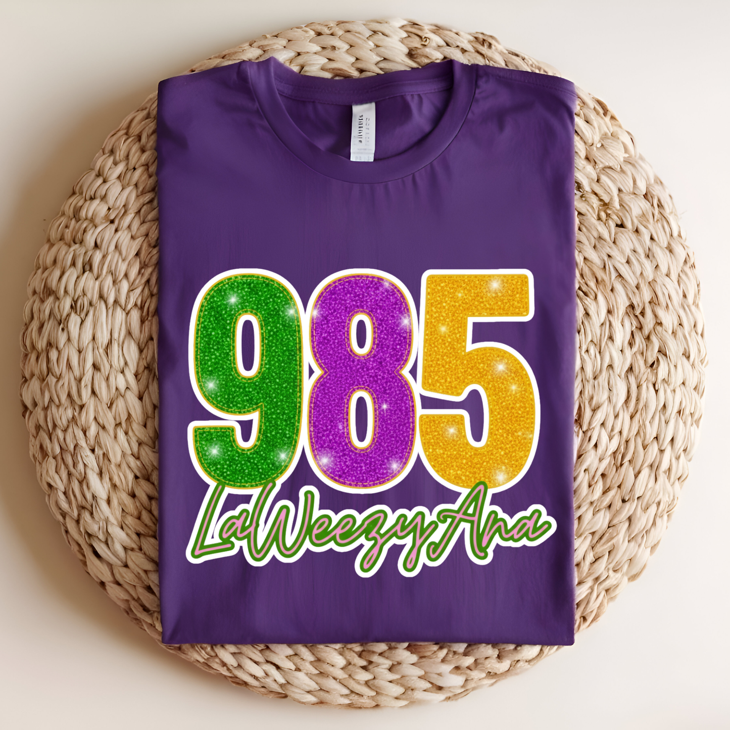 Purple t-shirt with colorful numbers and text on a woven mat