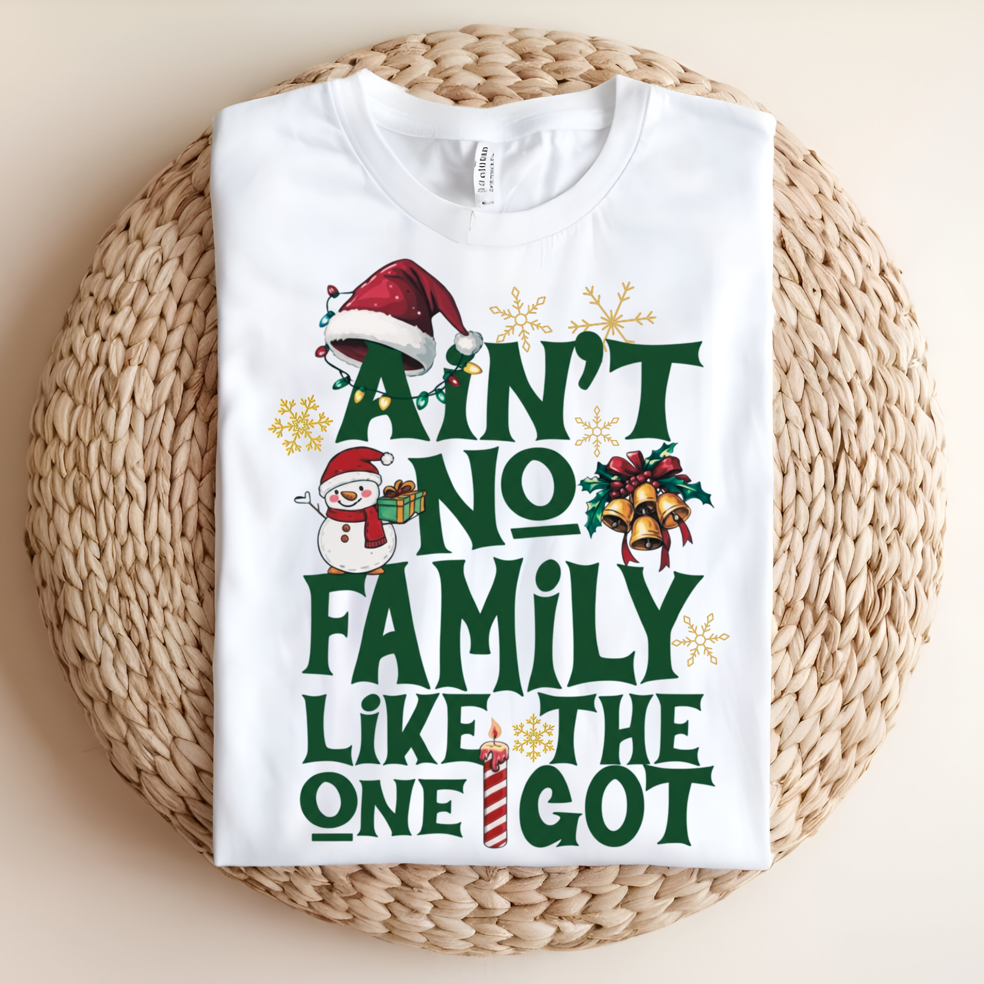 White t-shirt with Christmas-themed text and graphics on a woven surface
