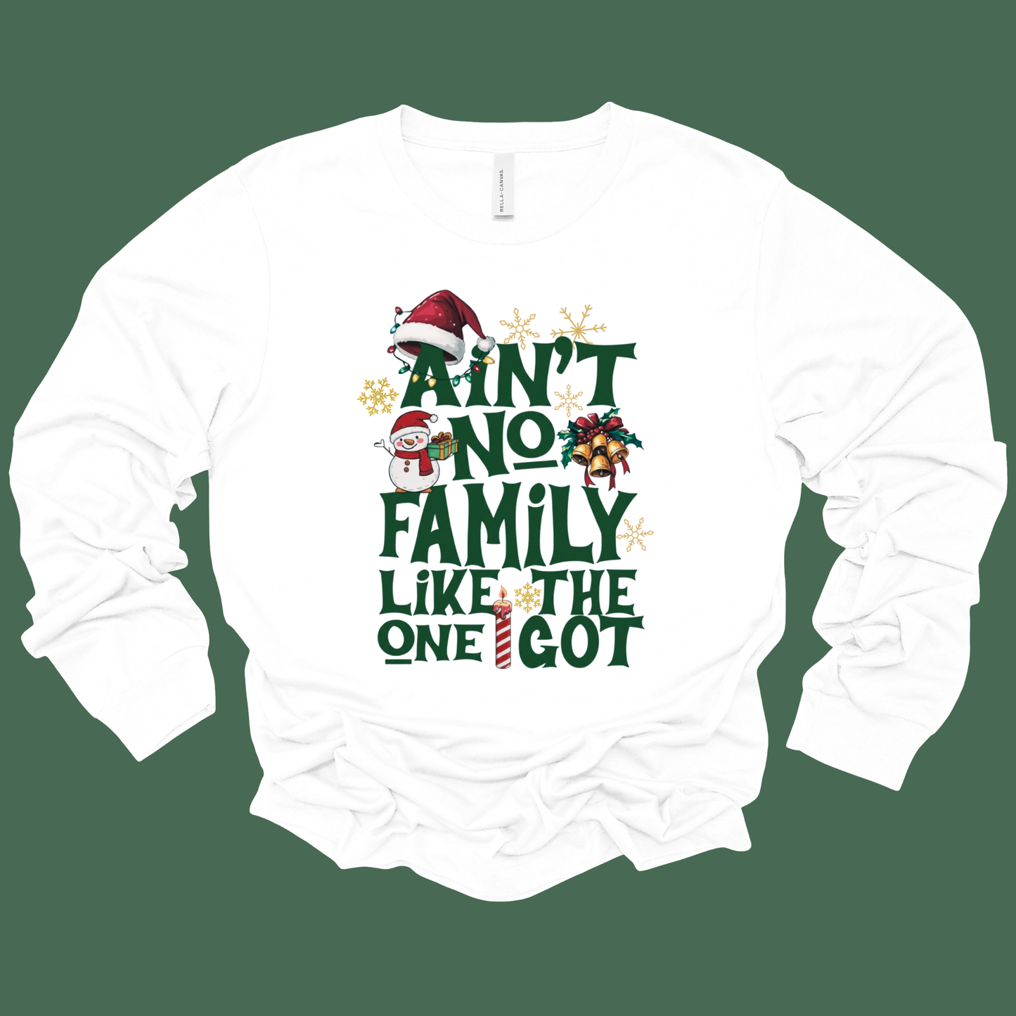White long-sleeve shirt with Christmas-themed text and graphics on a green background