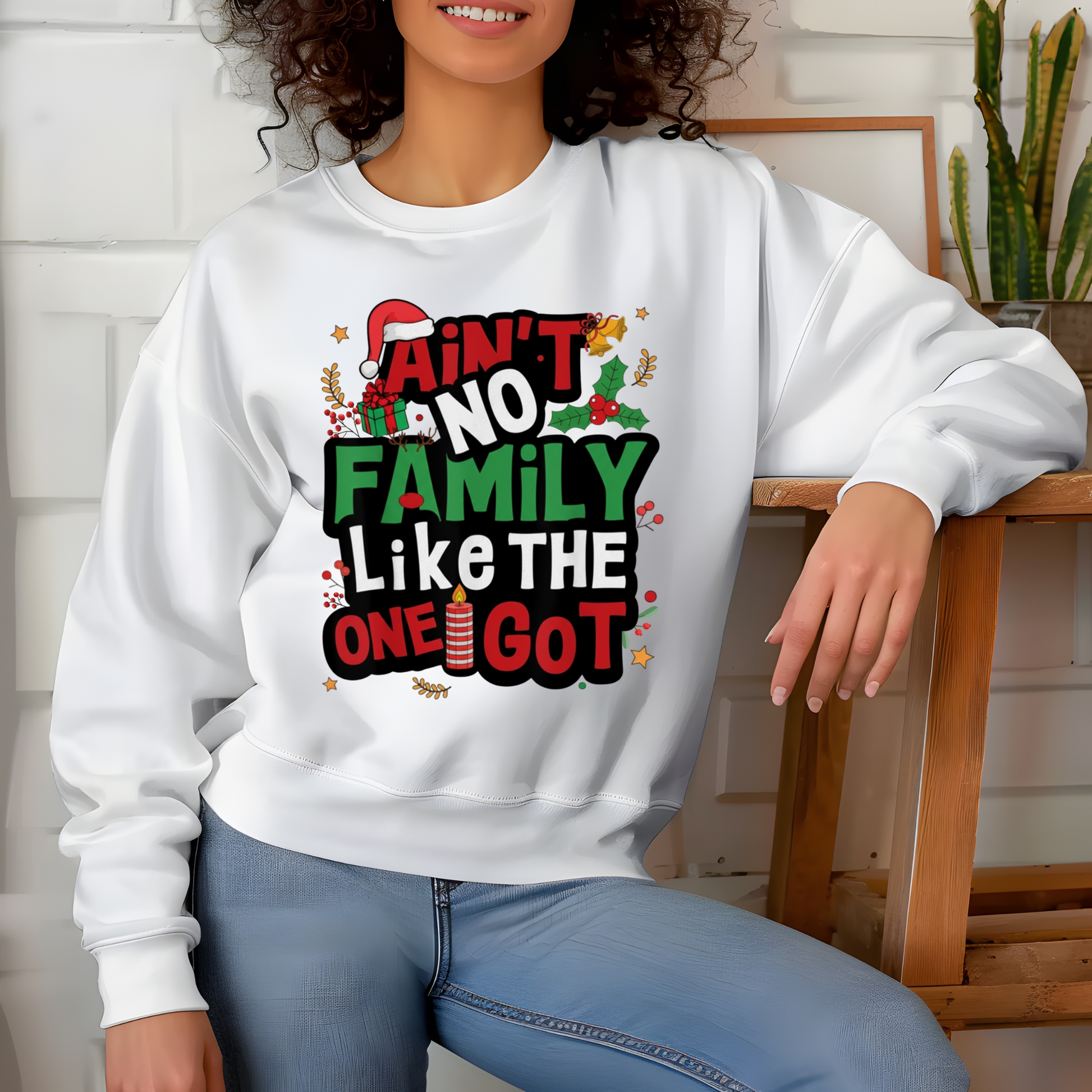 Person wearing a white sweatshirt with Christmas-themed text