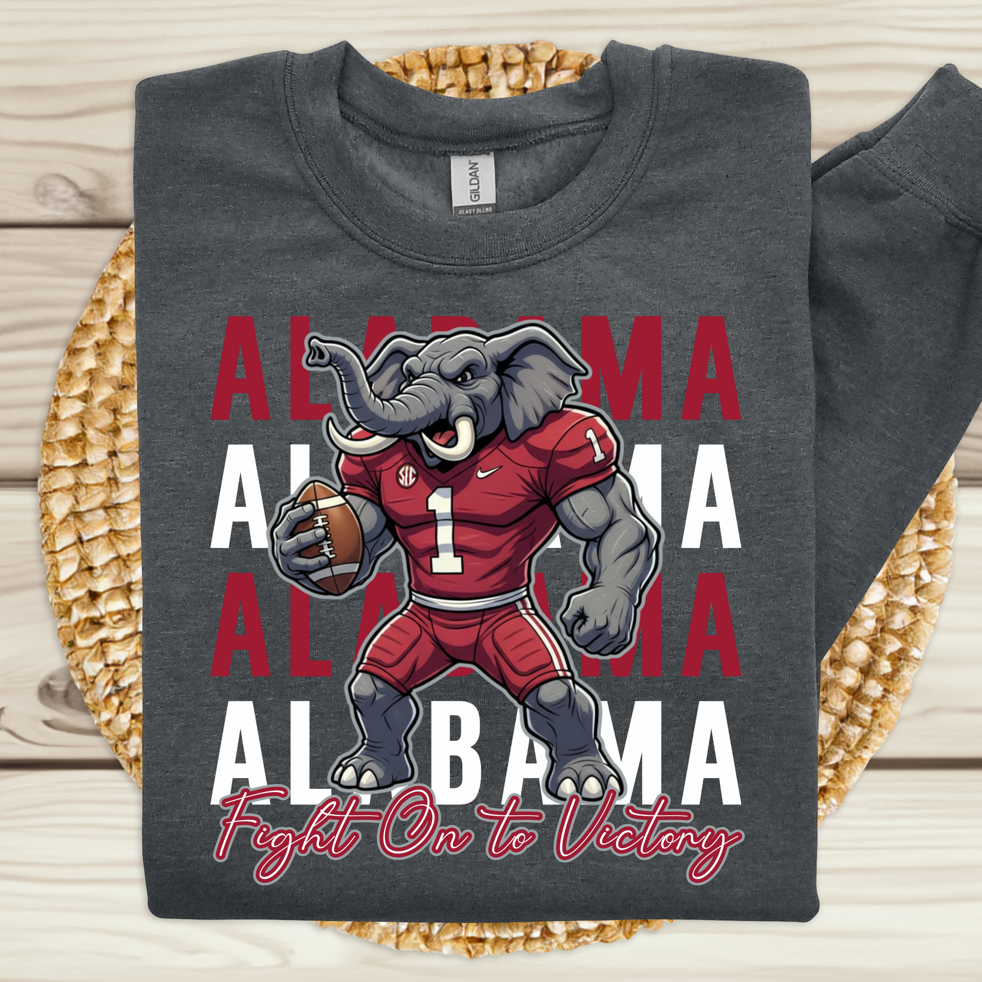 Gray t-shirt with Alabama-themed design featuring a cartoon elephant in a red jersey on a woven mat  Alabama Football "Fight on to Victory" Alabama Crimson Tide University Crewneck Sweatshirt