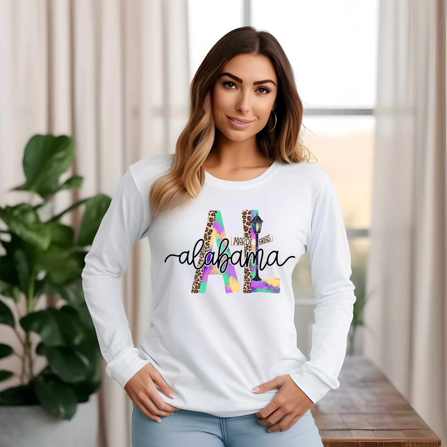 Woman wearing a white long-sleeve shirt with 'Alabama' design in a home setting