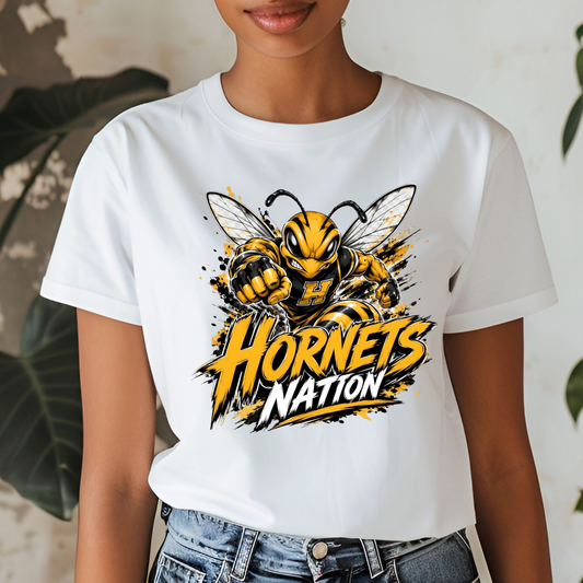 A white short-sleeve graphic t-shirt featuring a cartoon hornet mascot and the text 'Hornets Nation' in yellow and black, worn by a model with blue jeans.