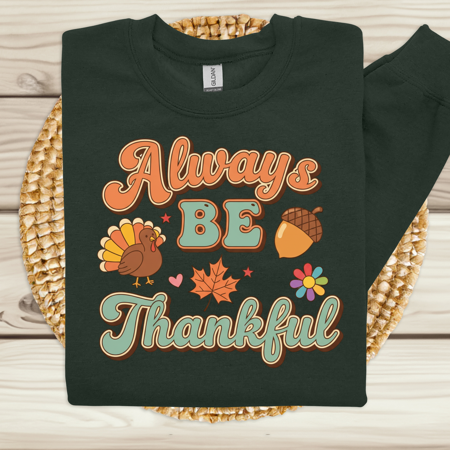Black sweatshirt with 'Always Be Thankful' text and fall-themed graphics on a woven mat. Retro Thanksgiving Sweatshirt "Always Be Thankful" Fall Harvest Crewneck Sweater