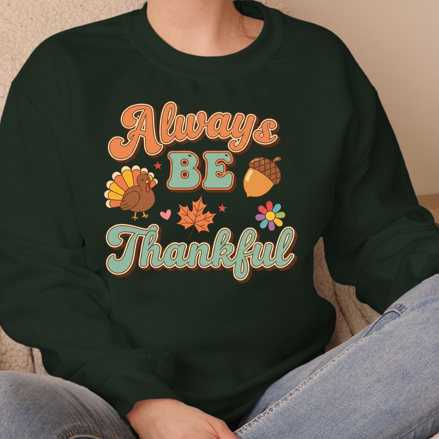 Person wearing a black sweatshirt with 'Always Be Thankful' text and Thanksgiving-themed graphics. Retro Thanksgiving Sweatshirt "Always Be Thankful" Fall Harvest Crewneck Sweater