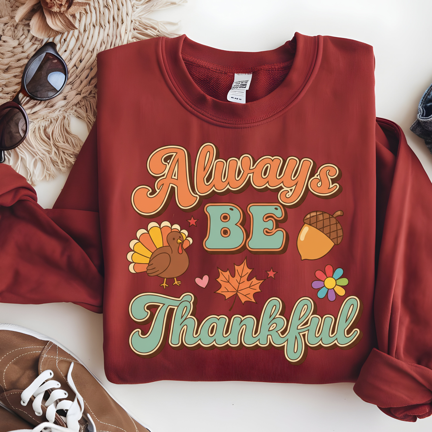 Maroon sweatshirt with 'Always Be Thankful' text and Thanksgiving graphics on a white surface.  Retro Thanksgiving Sweatshirt "Always Be Thankful" Fall Harvest Crewneck Sweater