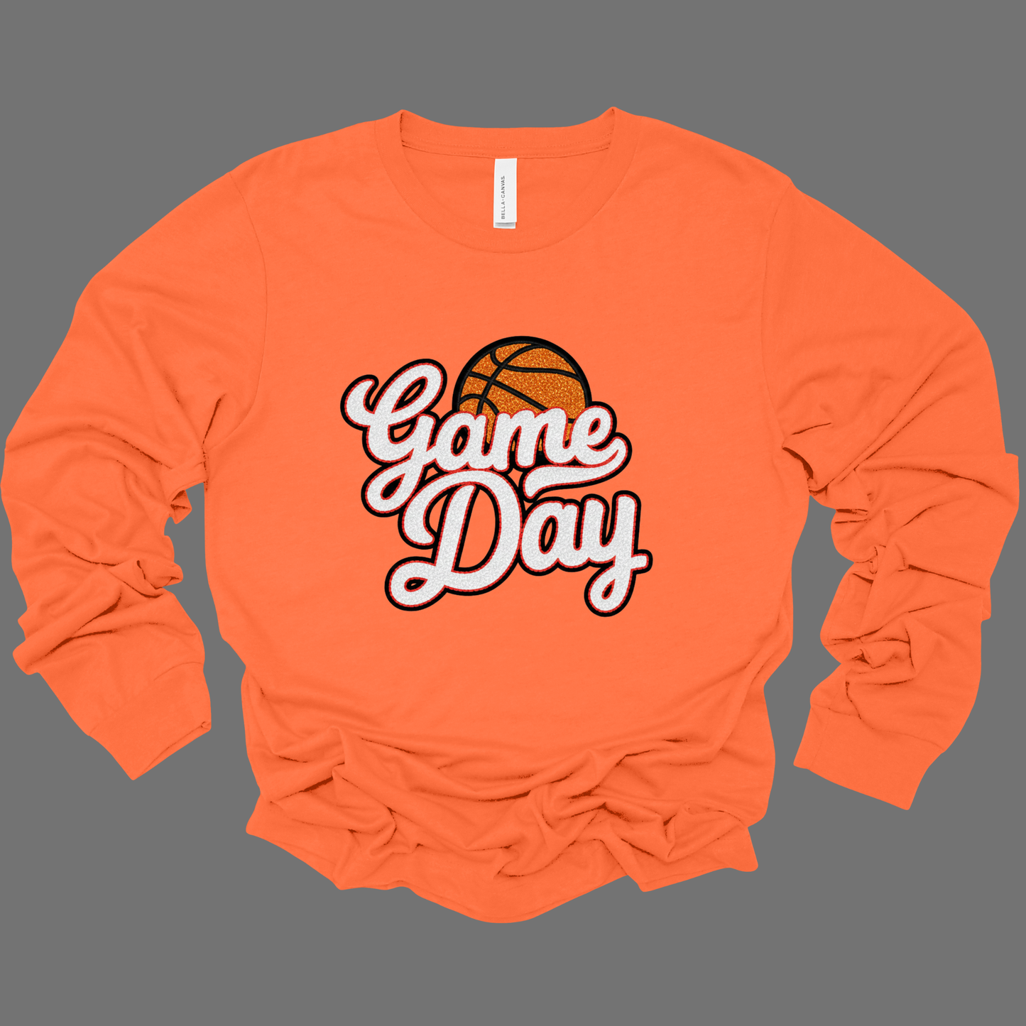 Orange long-sleeve shirt with 'Game Day' and basketball graphic on a gray background