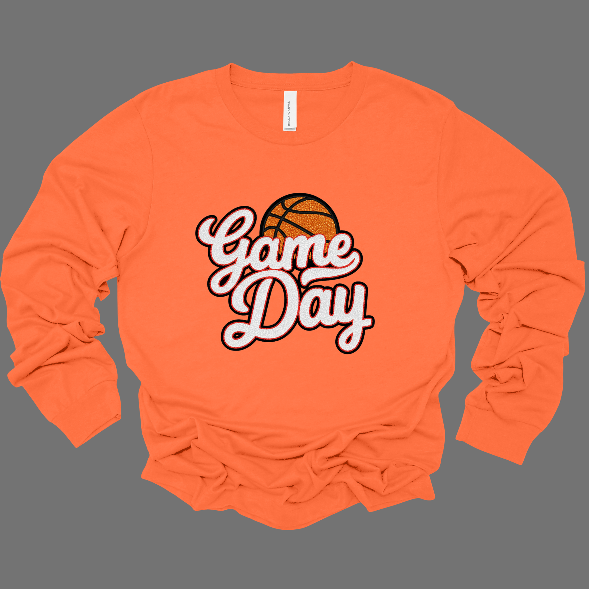 Orange long-sleeve shirt with 'Game Day' and basketball graphic on a gray background