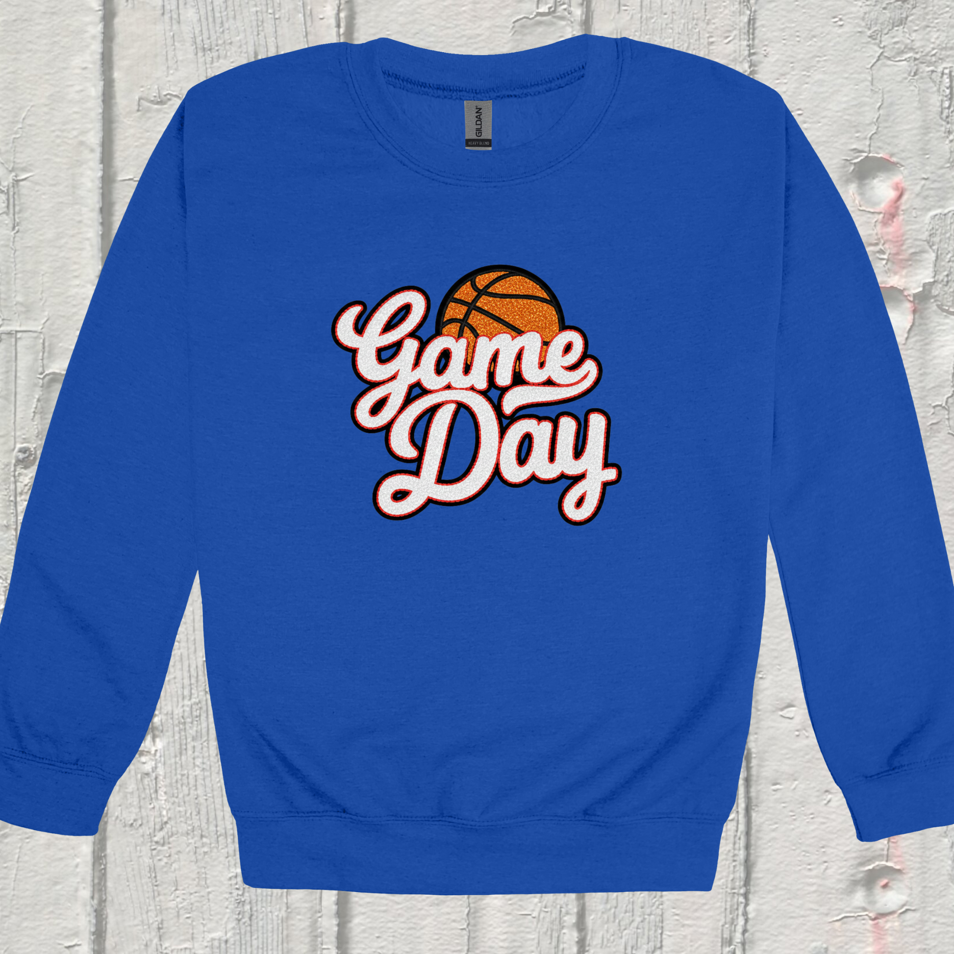 Blue sweatshirt with 'Game Day' and basketball graphic on a textured light gray background