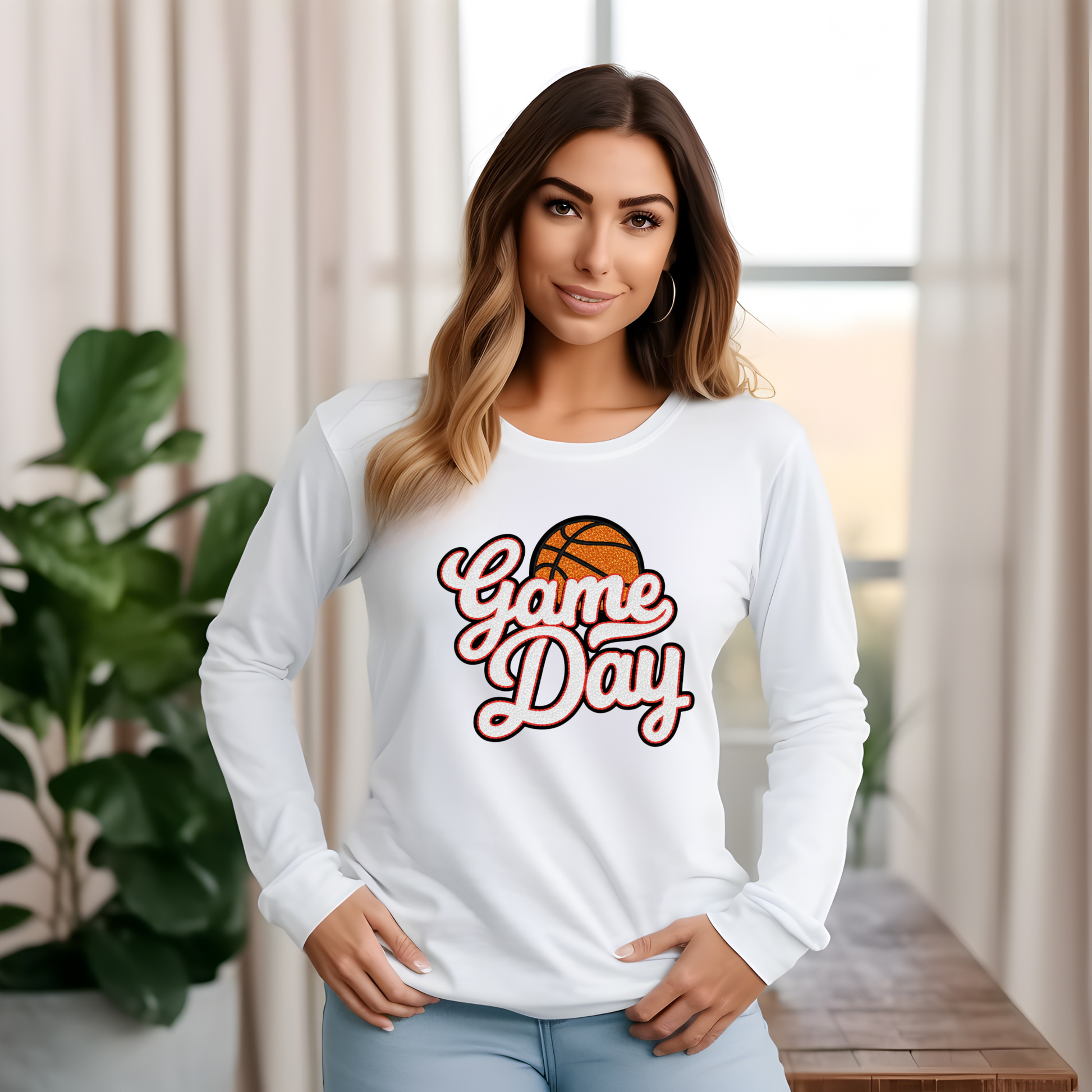 Woman wearing a white long-sleeve shirt with 'Game Day' and basketball graphic.